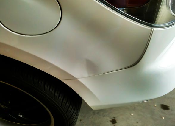 2010 Mazda CX-7 with dent in rear fender